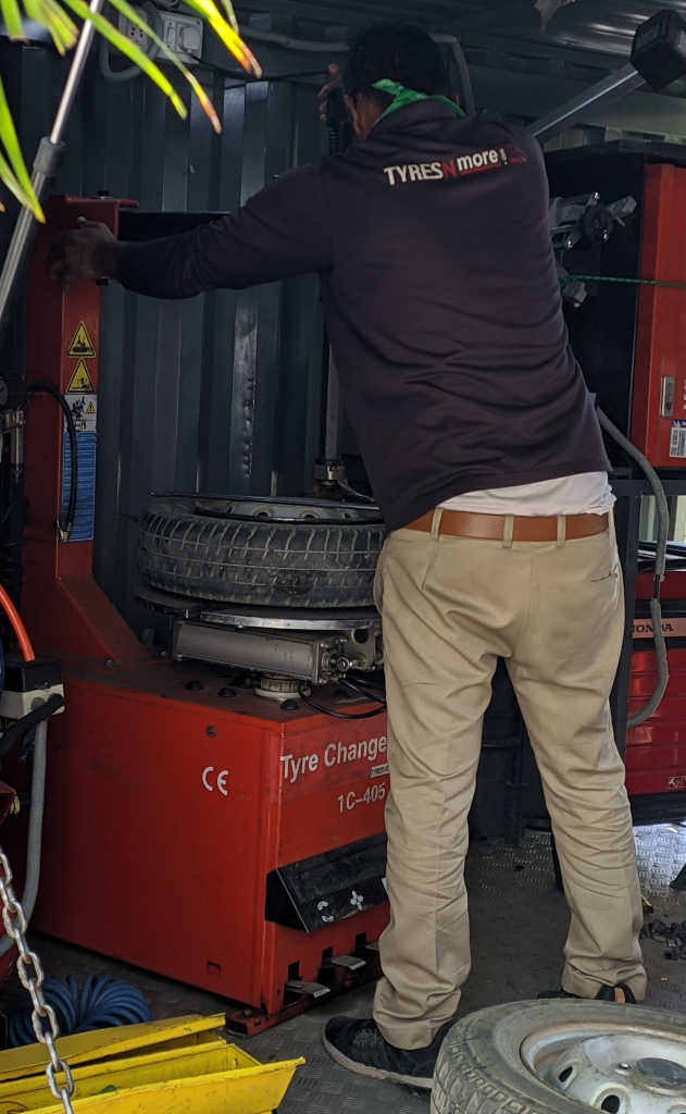 TyresNmore service personnel operating the tyre changing machine